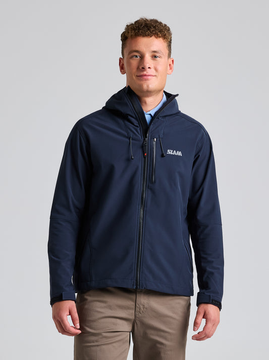 A person wearing a DARK NAVY SLAM SOFTSHELL HOODIE and khaki pants stands against a plain background, perfect for outdoor activities.