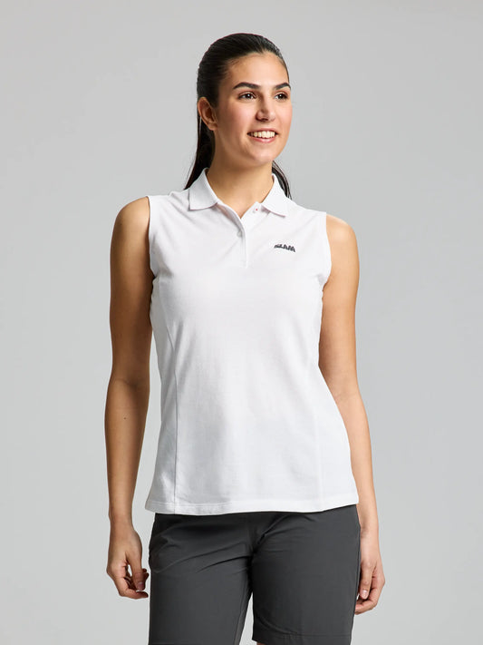 A woman is wearing a DOCK WOMAN POLO SLEEVELESS CL by SLAM in bright white, paired with dark pants, and smiling against a plain background.